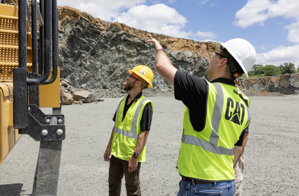 two men looking at truck